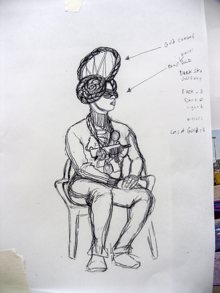 A pen drawing of a seated model wearing a large braided headdress and guns suspended from necklaces.