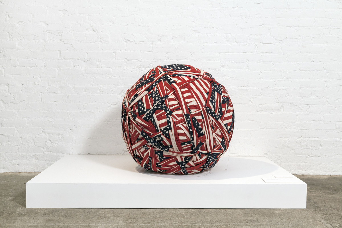 Exhibition view of the piece titled American Flag Ball #2 by Donald Lipski.