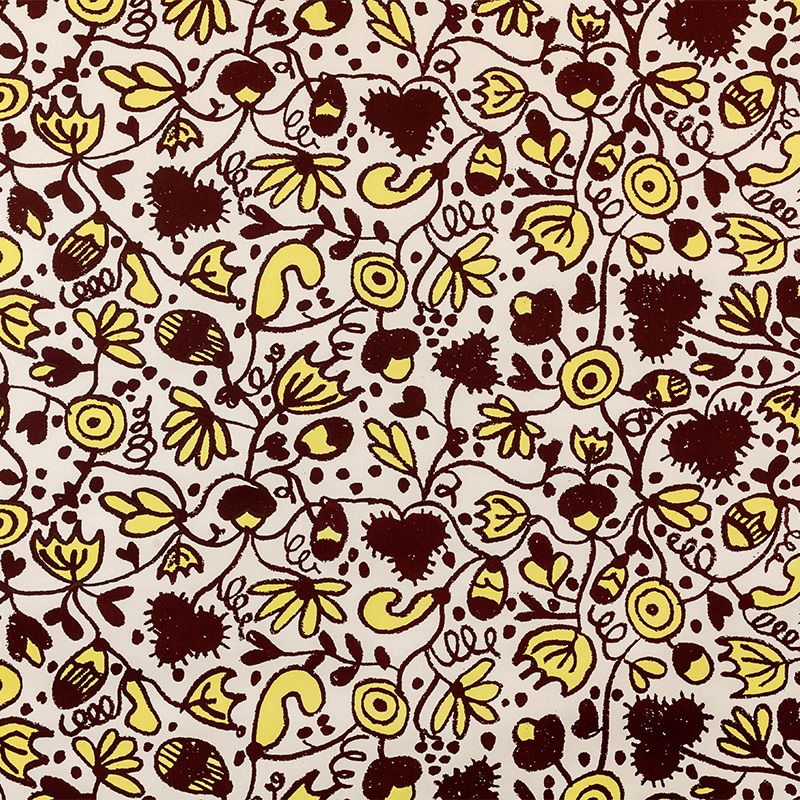 Fabric yardage consisting of bold, illustrated brown and yellow floral motifs.