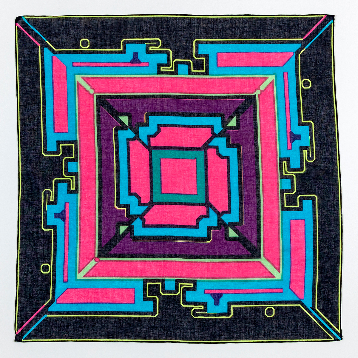 A square hankerchief with bold geometric patterns made up of black, light blue, magenta, and maroon shapes emanating radially from the center.