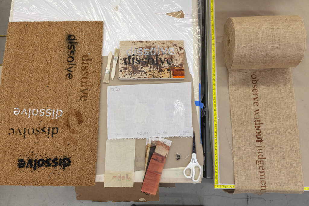 A photo of burlap materials with the word 'dissolve' printed.