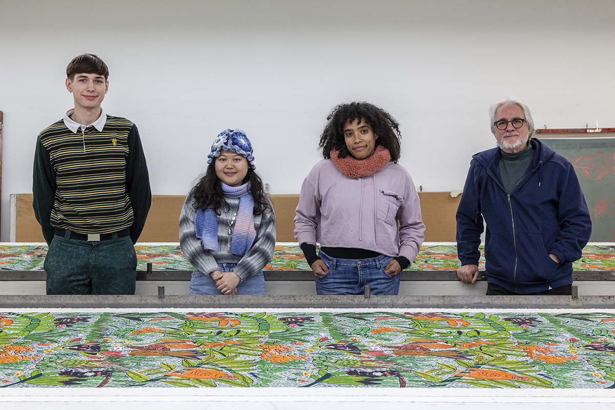 A photograph of FWM's Spring 2025 Apprentices in the Print Studio. From left to right are artists Chris Gaehde, Ruth (Xu) Huang, Sarah Lewis, and Greg Martino, each facing the camera.