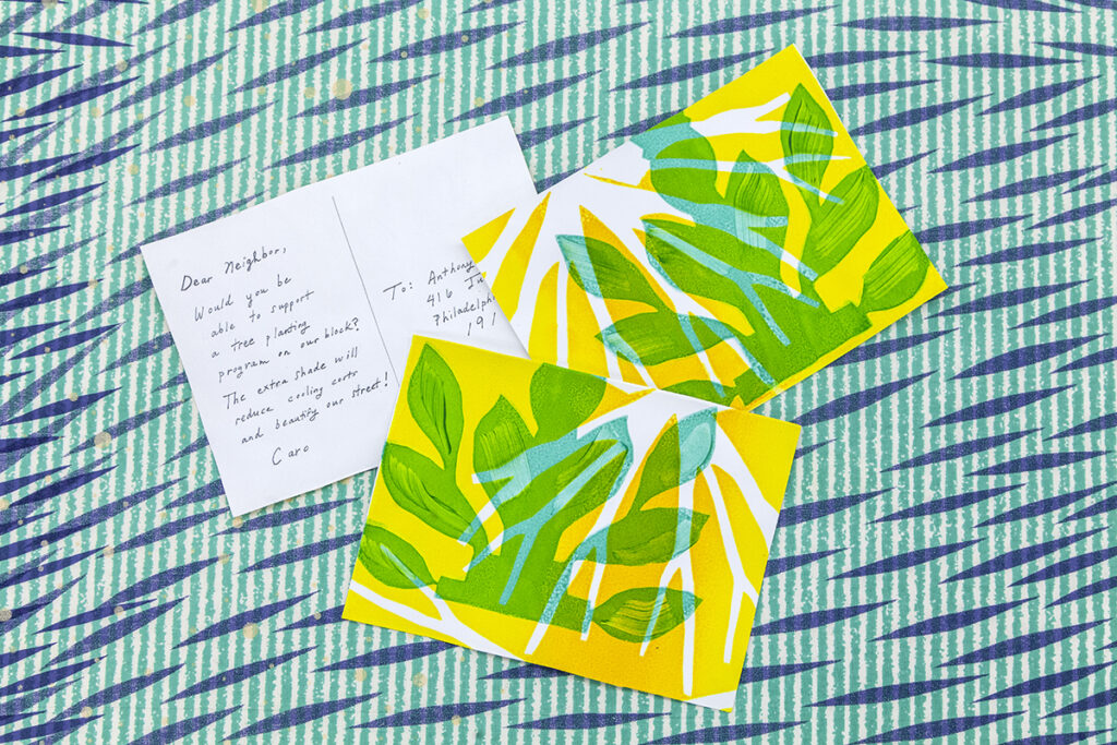 A vibrant screenprinted card with a botanical design on one side and a handwritten message to a friend on the other.