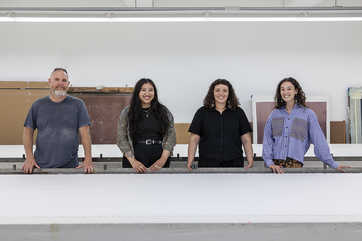 A photograph of FWM's Summer 2025 Apprentices in the Print Studio. From left to right are artists Matt Johnson, Margery Cercado, Ava Hassinger, and Isabel Hajian, each facing the camera.
