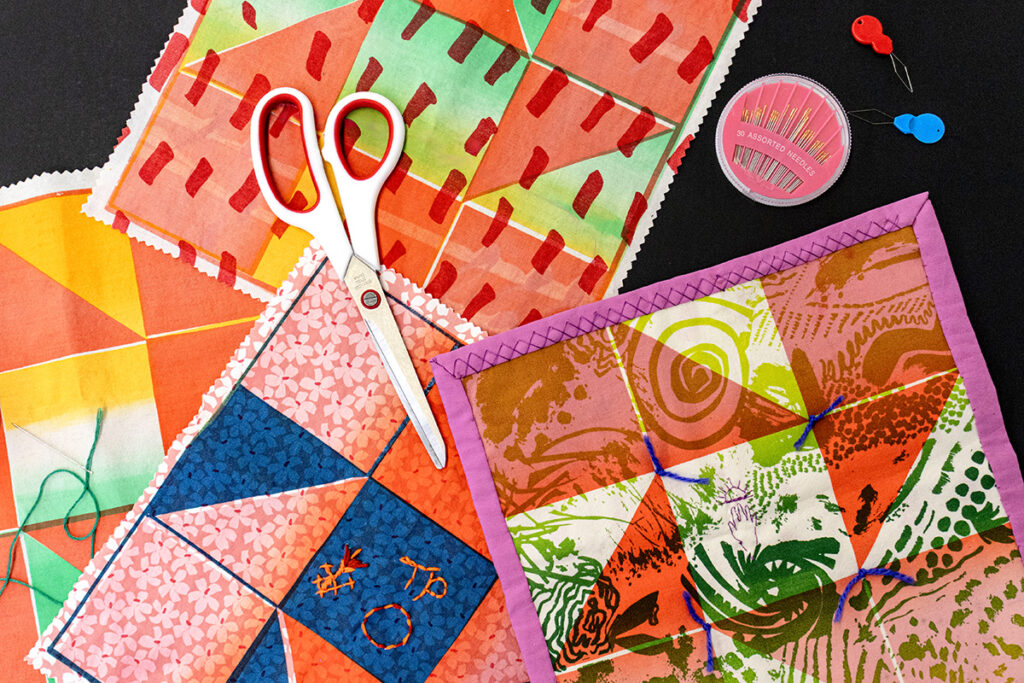 An assortment of screenprinted quilt squares at different levels of completion.
