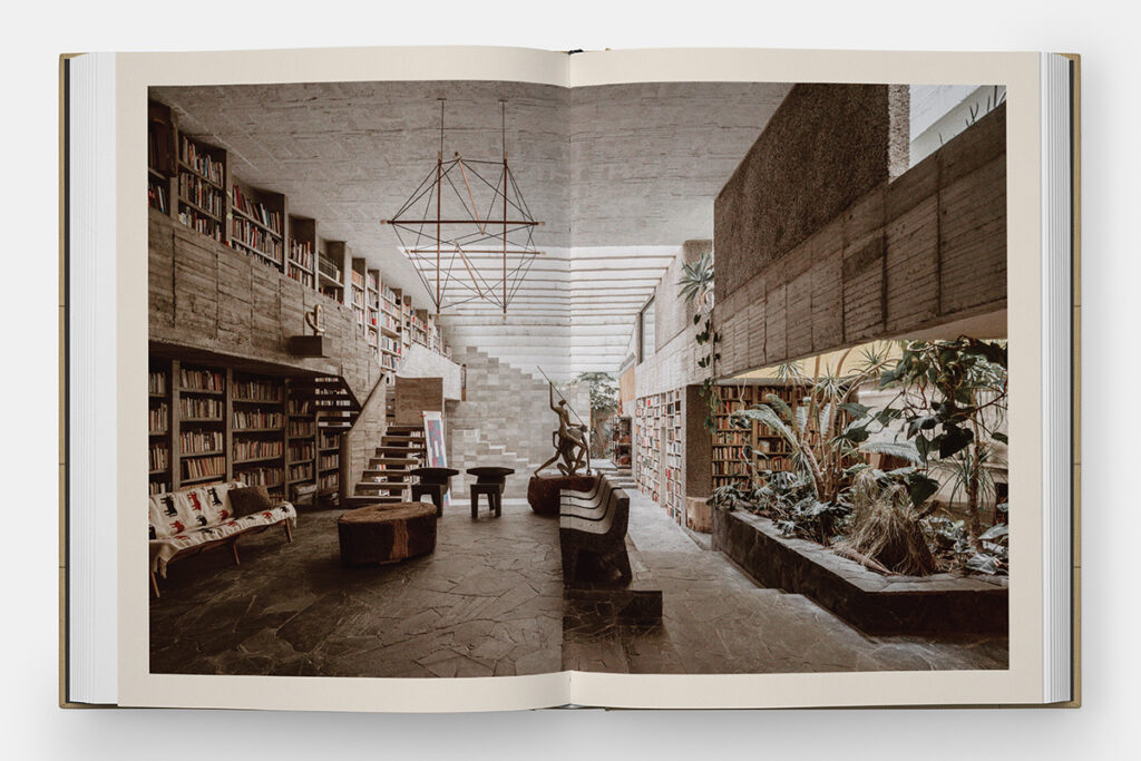 A photograph of an open book spread featuring a photograph of a well designed library interior spanning both pages.